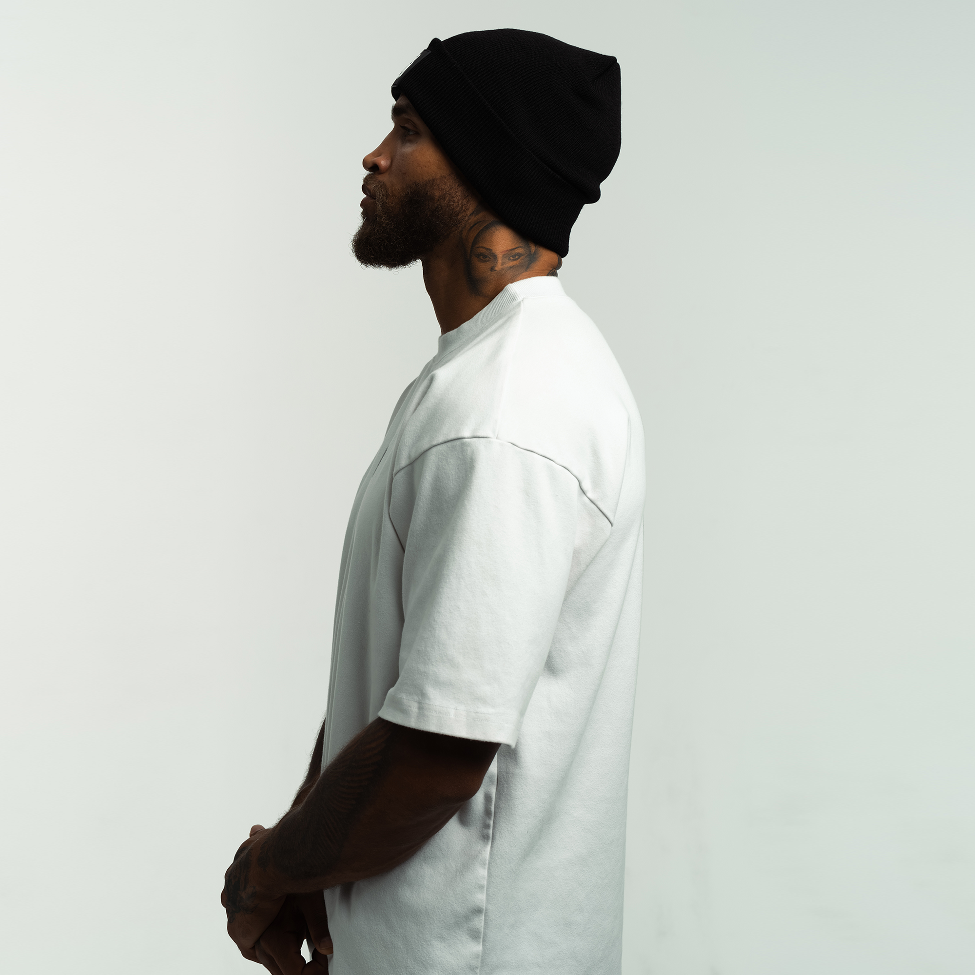 Side view of Patch Logo Beanie Worn by a model