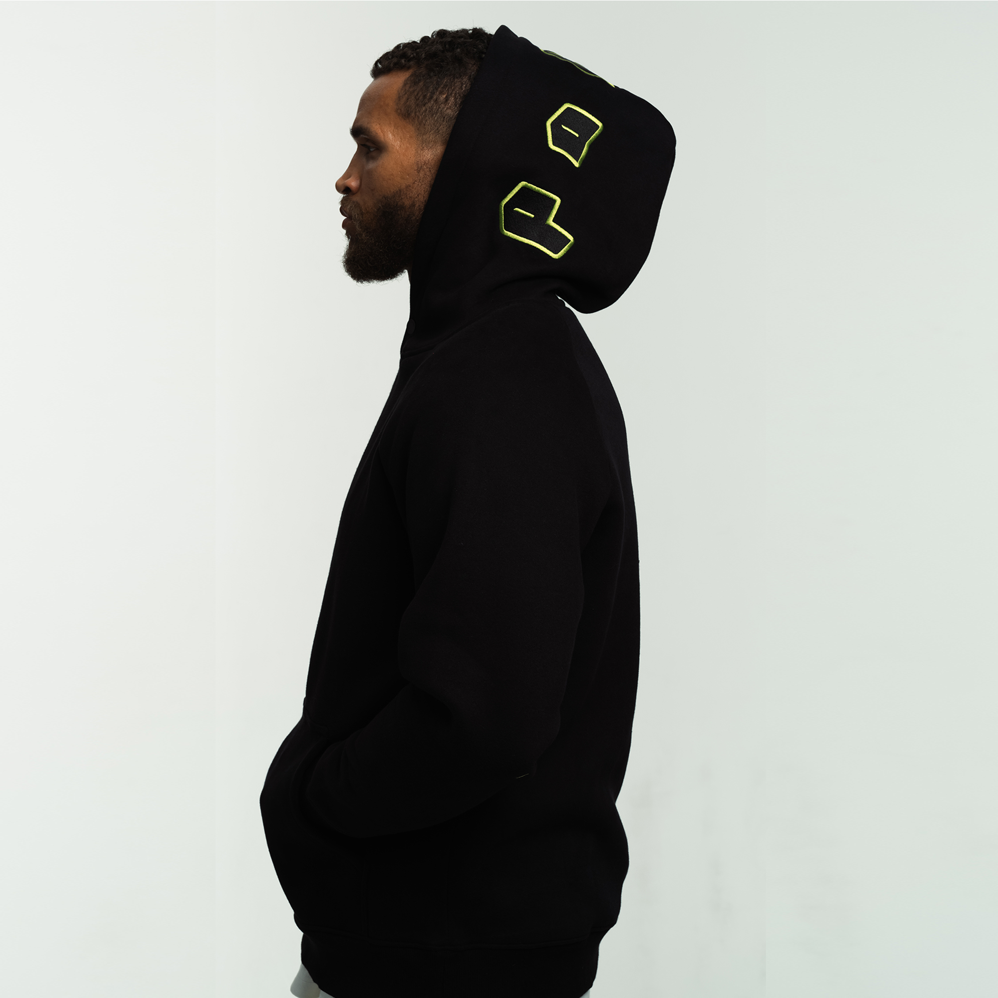 Side View of the Patch Signature Embroidered Hoody worn by a model